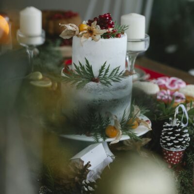 Christmas cake on table decorated with leaves and berries