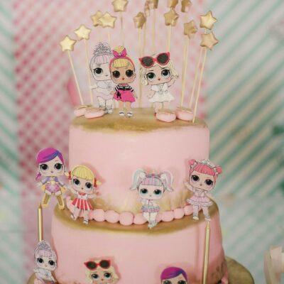 Pink birthday cake with small edible toys