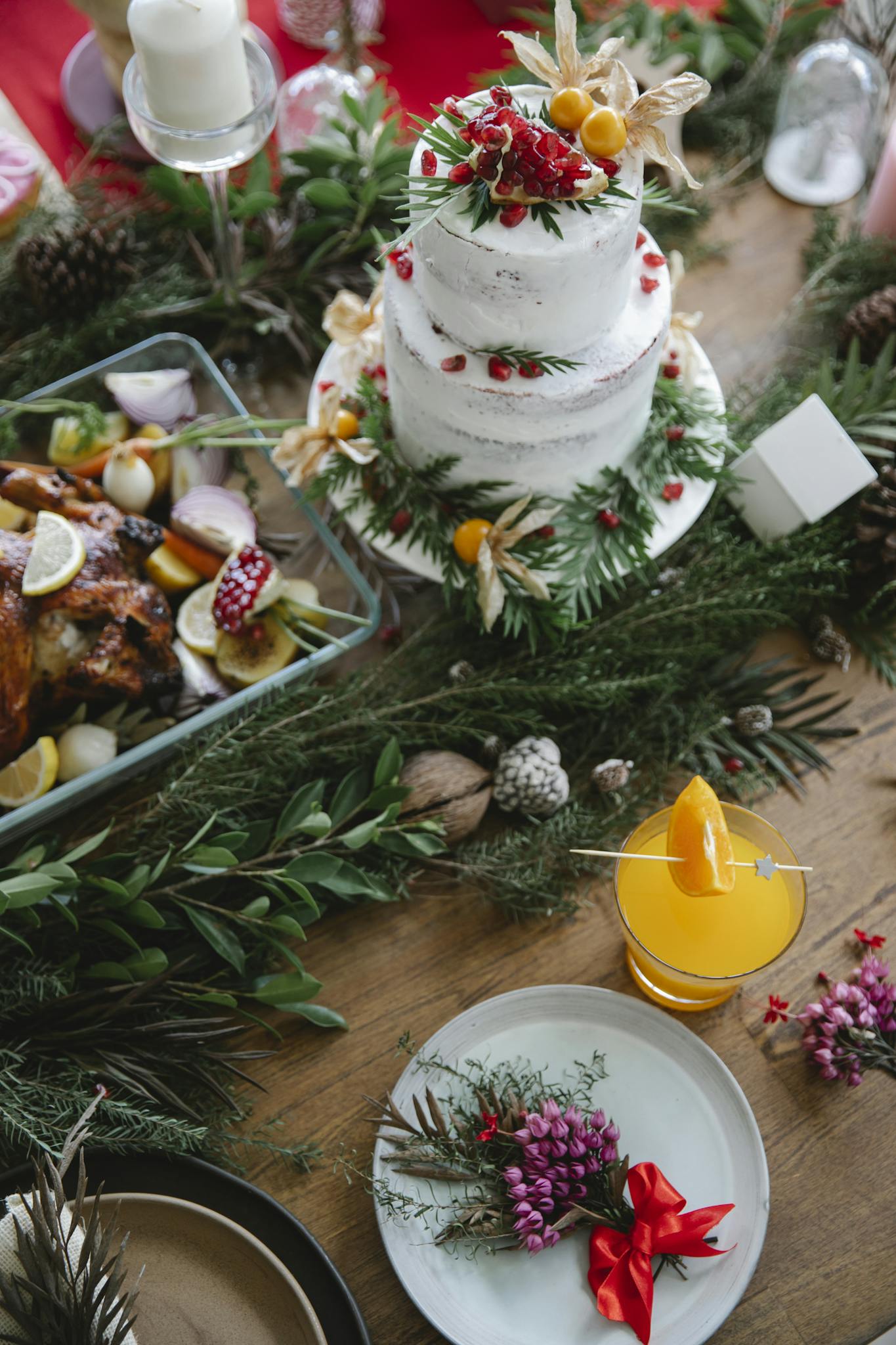Christmas table with cake with leaves and berries near drink