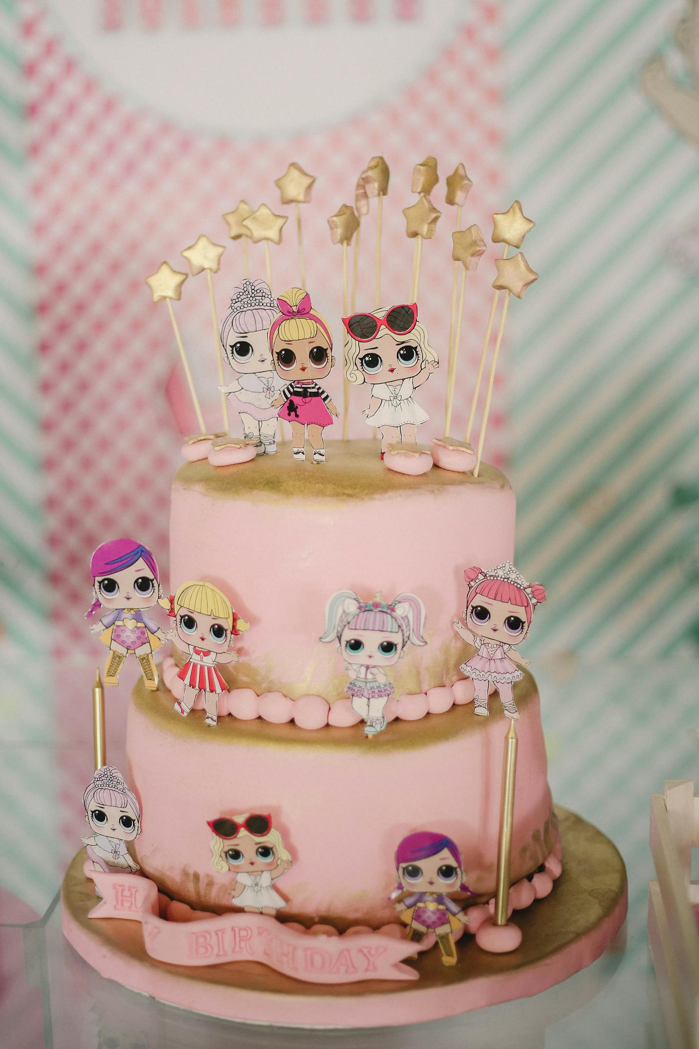 Pink birthday cake with small edible toys